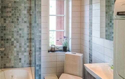 a bathroom with a tub and a sink and a window at Amazing Home In Höör With Wifi in Höör