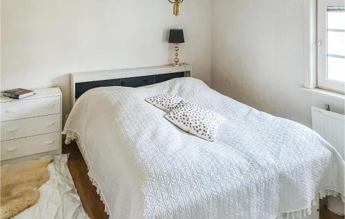 a bedroom with a bed with two pillows on it at Nice Home In Ljusne With Wifi in Ljusne