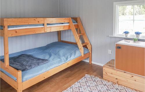 a bedroom with a bunk bed with a blue mattress at Nice Home In Ljusne With Wifi in Ljusne