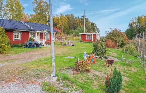 a group of children in a yard in front of a house at Nice Home In Ljusne With Wifi in Ljusne