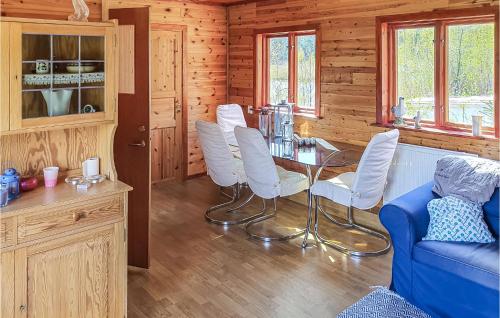 a dining room with a table and white chairs at Nice Home In Ljusne With Wifi in Ljusne