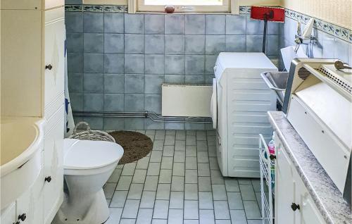 a small bathroom with a toilet and a sink at Nice Home In Ljusne With Wifi in Ljusne
