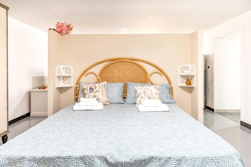 a bedroom with a large blue bed with pillows at A casa di Pietro Quattro in Leporano