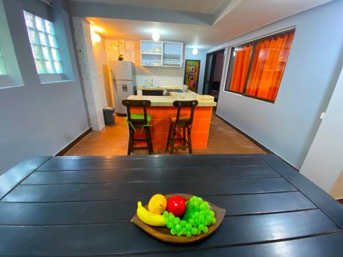 a bowl of fruit on a table in a kitchen at Finca Villa Chalet Del Rio Cali Farm Villa Chalet Cali River in Cali