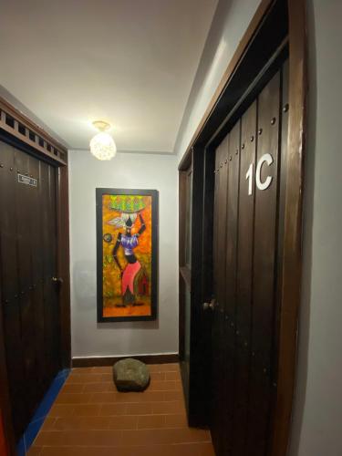a hallway with a painting on the wall next to a door at Finca Villa Chalet Del Rio Cali Farm Villa Chalet Cali River in Cali