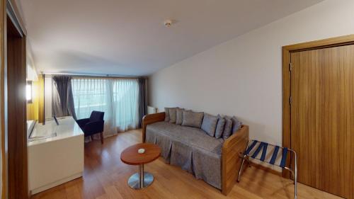 a living room with a couch and a table at Mimi Hotel Ankara in Ankara