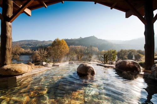 a swimming pool with rocks in the water at Home Las Burgas D&C in Ourense