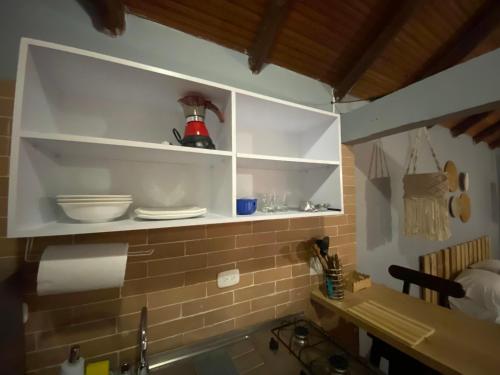 a kitchen with white cabinets and a sink with dishes at Finca Villa Chalet Del Rio Cali Farm Villa Chalet Cali River in Cali
