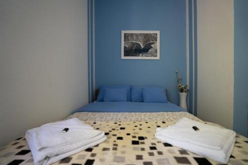 a bedroom with a bed with towels on it at Biserna Dolina Uvac in Sjenica