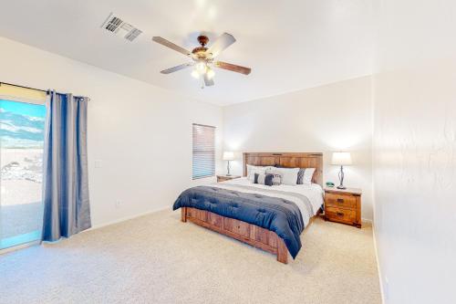 a bedroom with a bed and a ceiling fan at North Twin Lakes Abode in Catalina