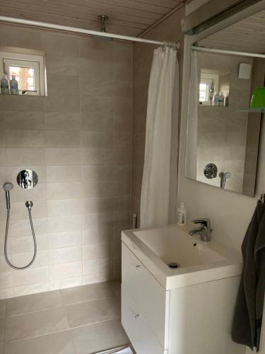a white bathroom with a sink and a shower at BB-Risskov in Risskov
