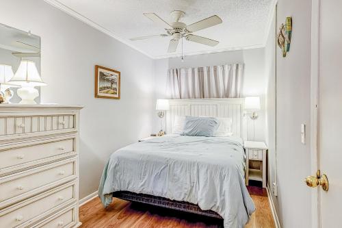 a white bedroom with a bed and a ceiling fan at HH Beach & Tennis 246B in Hilton Head Island