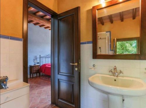 a bathroom with a sink and a mirror at Il Nido country house in Montaione