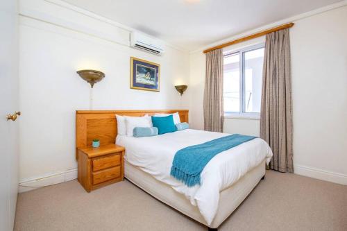 a bedroom with a large bed and a window at Sheer Nest in Knysna
