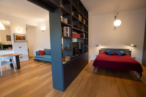 a bedroom with a bed and a living room at Fleming Magnolia, confortevole open space in Rome