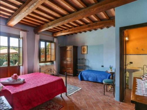 a bedroom with a red bed in a room at Il Nido country house in Montaione