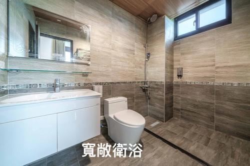 y baño con aseo, lavabo y ducha. en 馬在對面民宿, en Yilan City