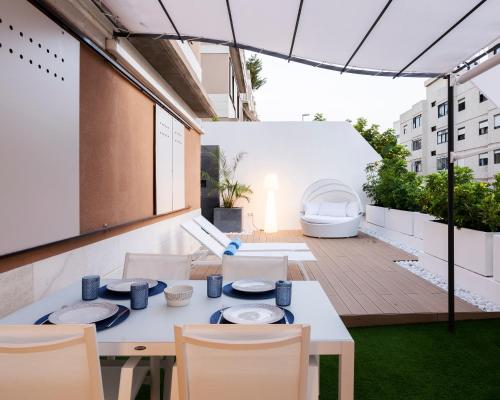 an outdoor patio with a white table and chairs at The Terraces Luxury Penthouses, 1D in Santa Cruz de Tenerife