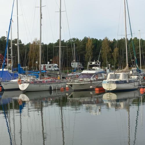 a group of boats are docked in the water at Apartament Orlando w Porto Łeba 350m od morza in Łeba