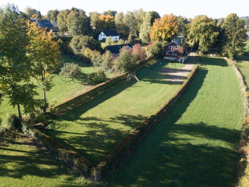 an aerial view of a field with a house and trees at Le Milan Royal 26 pers, Malmedy, Balnéo, vue, calme in Malmedy