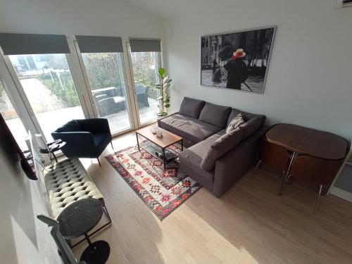 a living room with a couch and a table at Attefallshus säng 160 bäddsoffa 160 in Växjö