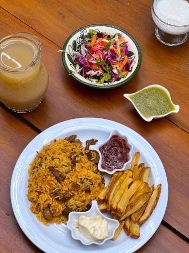 a plate of food with fried rice and a salad at Ocean Forest Ecolodge in San Pedrillo