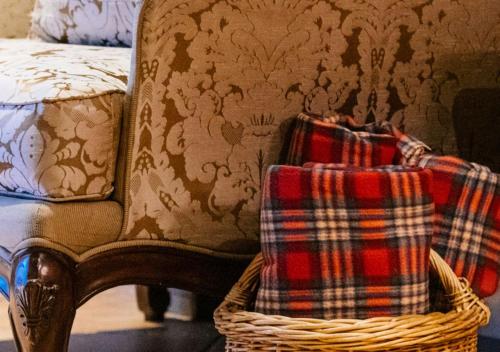 a chair with a plaid blanket and a basket at Dimora Buglioni Wine Relais in San Pietro in Cariano
