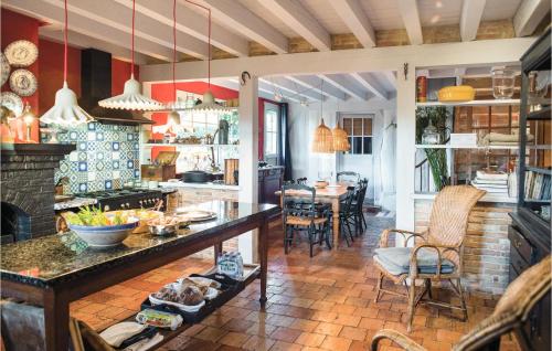 a kitchen and dining room with a table and chairs at 3 Bedroom Gorgeous Home In Arjuzanx in Arjuzanx