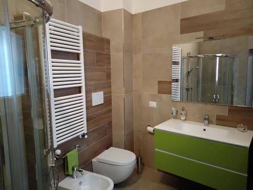 a bathroom with a toilet and a sink and a mirror at B&B Corso Trieste e Trento in Alberobello