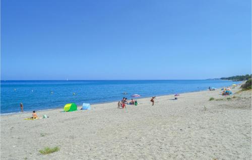a group of people on a beach near the water at Cozy Home In Moriani Plage With Wifi in Moriani Plage