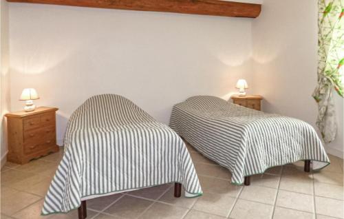 two beds sitting next to each other in a room at Awesome Home In Vaudoy-en-brie With 4 Bedrooms, Wifi And Indoor Swimming Pool in Vaudoy-en-Brie