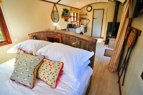 um quarto com uma cama com duas almofadas em Finest Retreats - Maple Luxury Shepherds Hut em Dittisham