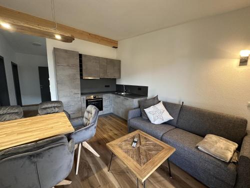 a living room with a couch and a table at Appart Anna in Scheffau am Wilden Kaiser