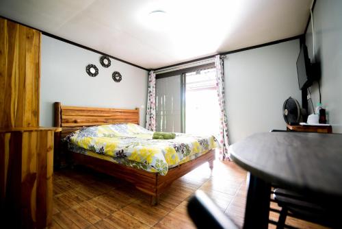 a bedroom with a bed and a window at One khaokho homestay in Khao Kho