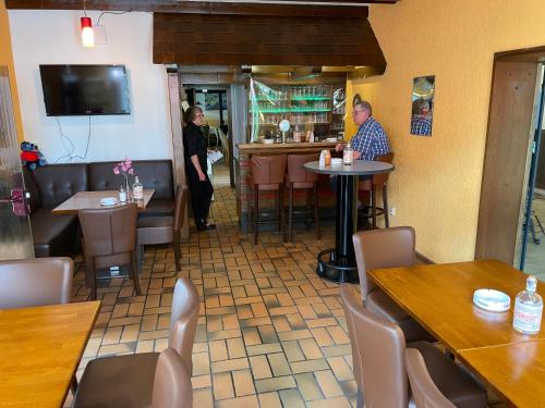 a restaurant with people sitting at tables in a restaurant at Hotel Martina in Bad Sooden-Allendorf