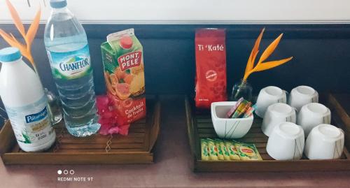 two wooden boxes with drinks and other items on a table at Appartement Ti Bato in Les Trois-Îlets