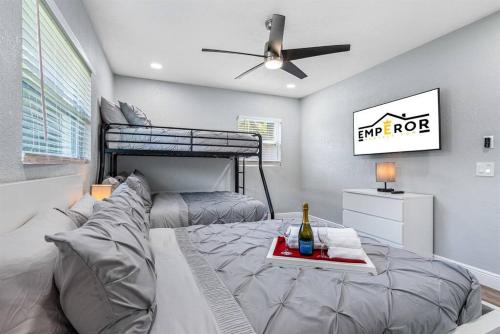 a bedroom with a bed and a bunk bed at Charming & Renovated Home 20 Minutes from Tampa in Brandon
