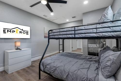 a bedroom with a bunk bed and a ceiling fan at Charming & Renovated Home 20 Minutes from Tampa in Brandon