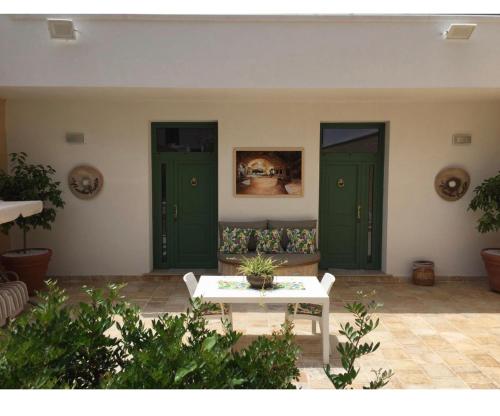 a living room with green doors and a couch at AL VECCHIO FRANTOIO in Manduria