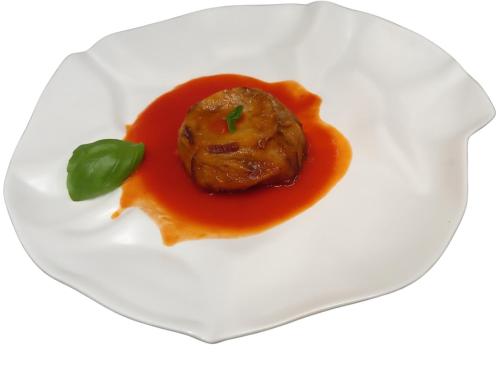 a white plate with a meatball in tomato sauce at Hotel Delfin Lanterna in Tar