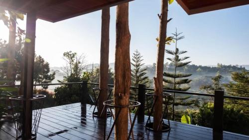 a balcony with trees and a view of the mountains at One khaokho homestay in Khao Kho