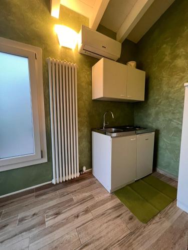 a small kitchen with a sink and a window at Antica Locanda Zio Cesare in Ferrara