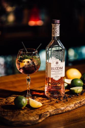 a bottle of liquor next to a glass of olives at High Force Hotel in Newbiggin