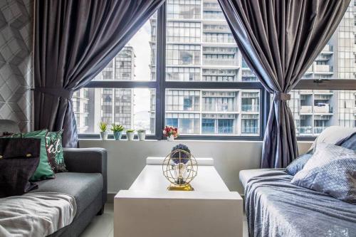 a living room with a couch and a window at The Arte Plus KLCC BY Tenang Homes in Kuala Lumpur