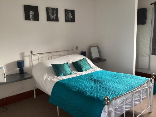 1 dormitorio con 1 cama con edredón azul en The Coach and Horses en Parkham