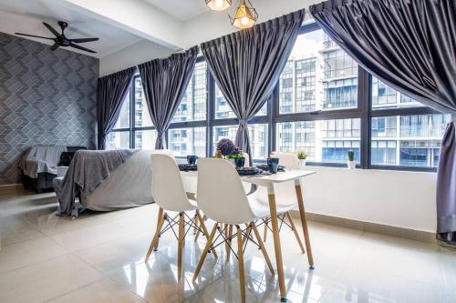 a bedroom with a table and two chairs and a bed at The Arte Plus KLCC BY Tenang Homes in Kuala Lumpur