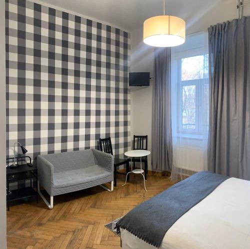a bedroom with a bed and a table and a window at Cent Hostel in Lublin