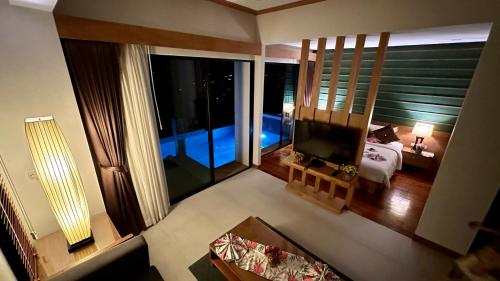 a view of a room with a bed and a television at Aonang Phu Dahla Private Pool & Sea View - SHA Plus in Ao Nang Beach