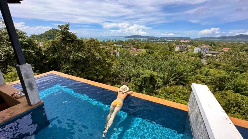 a person in a swimming pool at a resort at Aonang Phu Dahla Private Pool & Sea View - SHA Plus in Ao Nang Beach