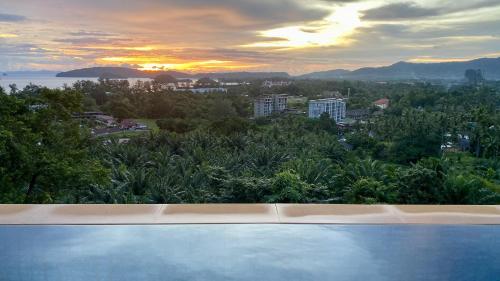 a swimming pool with a view of a city at Aonang Phu Dahla Private Pool & Sea View - SHA Plus in Ao Nang Beach